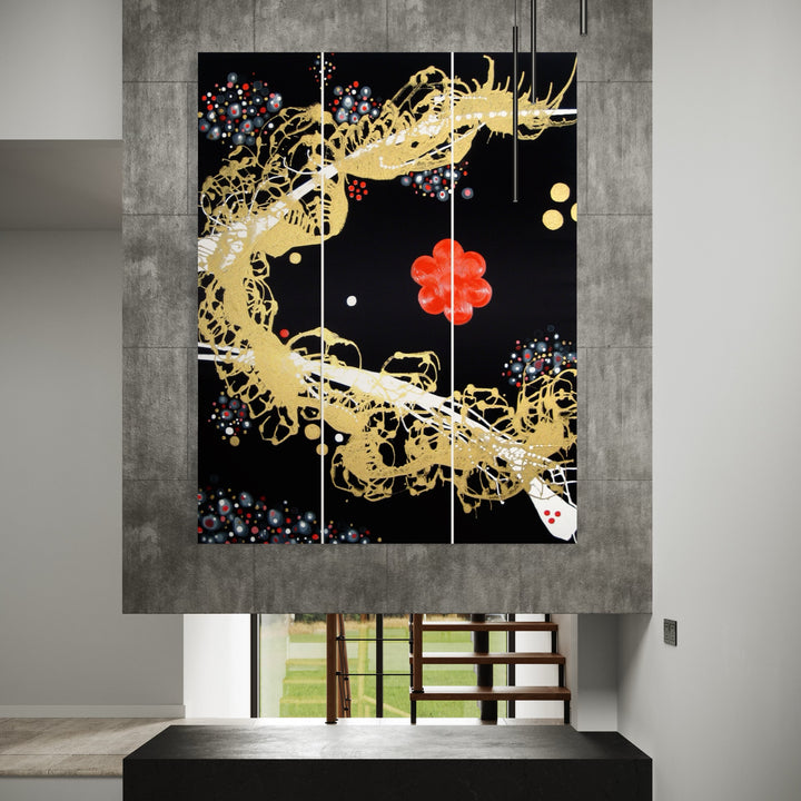 The artwork 'Anima Rising' triptych by Eric Jiaju Lee features a dynamic golden dragon-like form swirling across a black background, adorned with scattered blue and red floral elements. The abstract composition combines Asian-inspired motifs with contemporary aesthetics, rendered in acrylic on three connected canvases, measuring 72 x 55.5 inches by Eric Jiaju Lee.