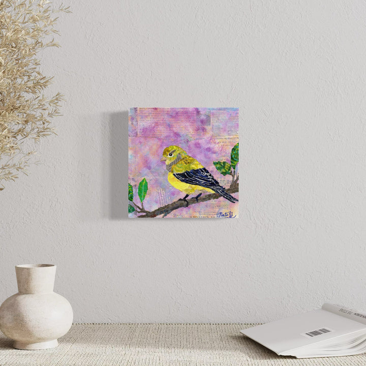 A photo of the artwork Backyard Birds: Mrs. Lesser Goldfinch, by Natasha Papousek, hanging on a wall.