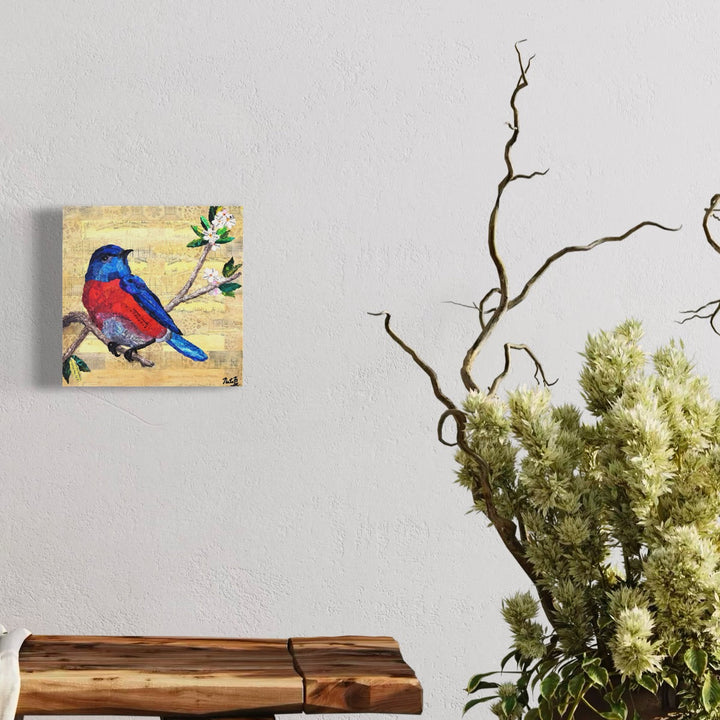 A photo of the artwork Backyard Birds: Western Bluebird, by Natasha Papousek, hanging on a wall.