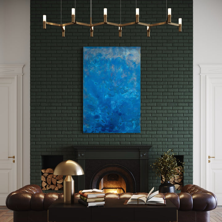 The artwork 'Biophilia 30' by George Stanojevic features a striking abstract composition dominated by deep azure and cerulean blue hues, creating a fluid, oceanic effect. The canvas showcases organic patterns and ethereal textures achieved through the natural interaction of pigments with sunlight, water, and earth elements. The large-scale artwork creates a dramatic focal point against dark walls.