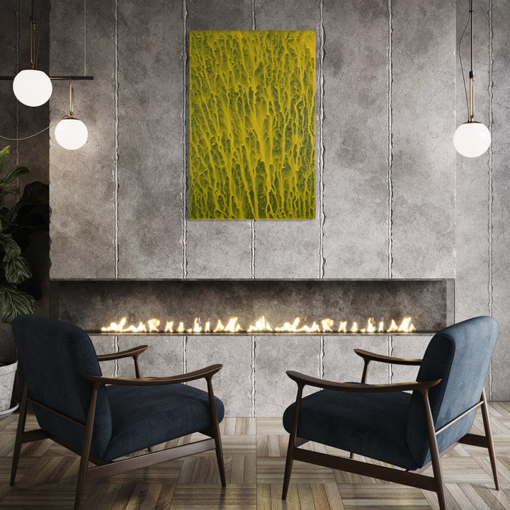 The artwork 'Biophilia 35' by George Stanojevic features a striking abstract composition in vibrant chartreuse and yellow hues, displaying organic drip patterns reminiscent of natural water flows. The textural canvas hangs against an industrial concrete wall, above a modern linear fireplace, creating a dramatic contrast between organic and architectural elements. By George Stanojevic.