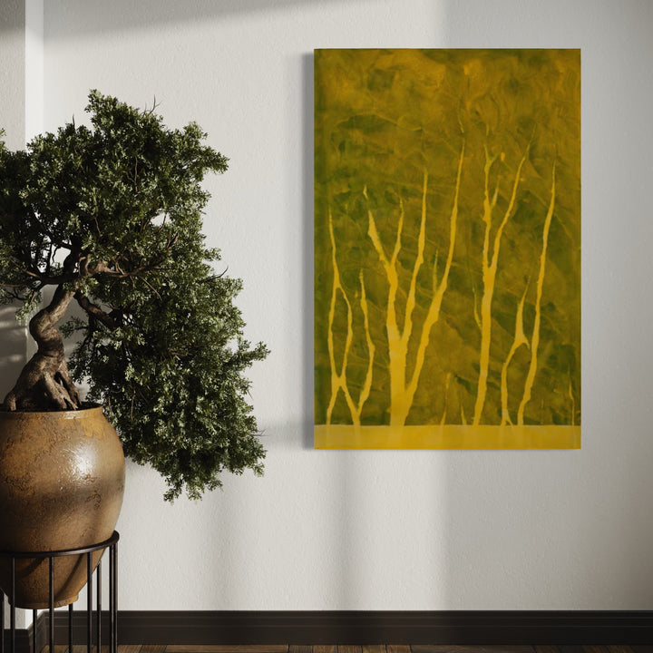 The artwork 'Biophilia 36' by George Stanojevic features ethereal golden tree silhouettes against a moss-green background, creating a mystical forest atmosphere. The textured canvas shows subtle variations in pigment, with delicate branches reaching upward in an abstract, naturalistic style. Natural elements like sunlight and water have influenced the organic, earthy composition.