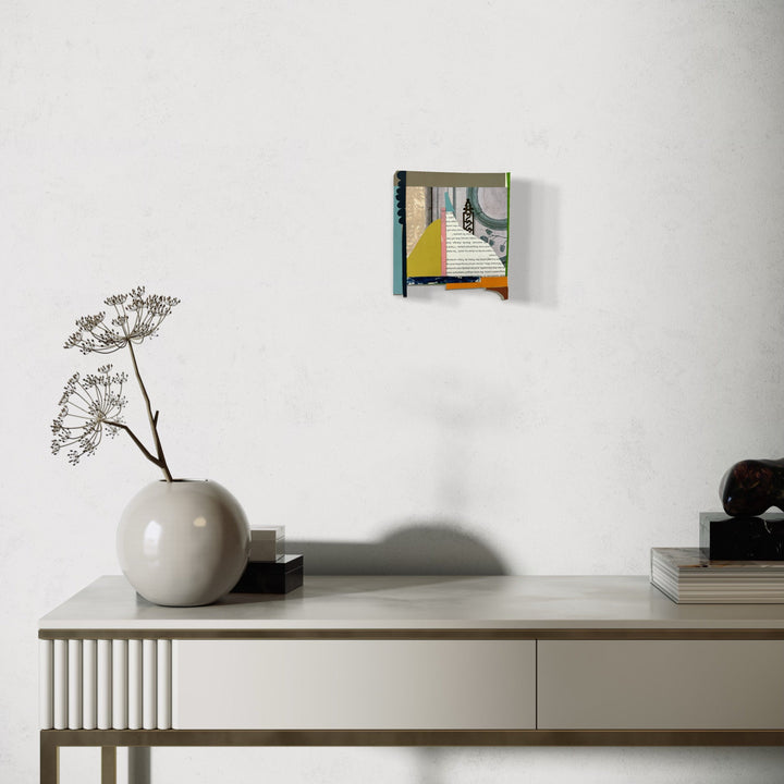 A photo of the artwork Box Top no. 56, by Janice La Motta, hanging on a wall.