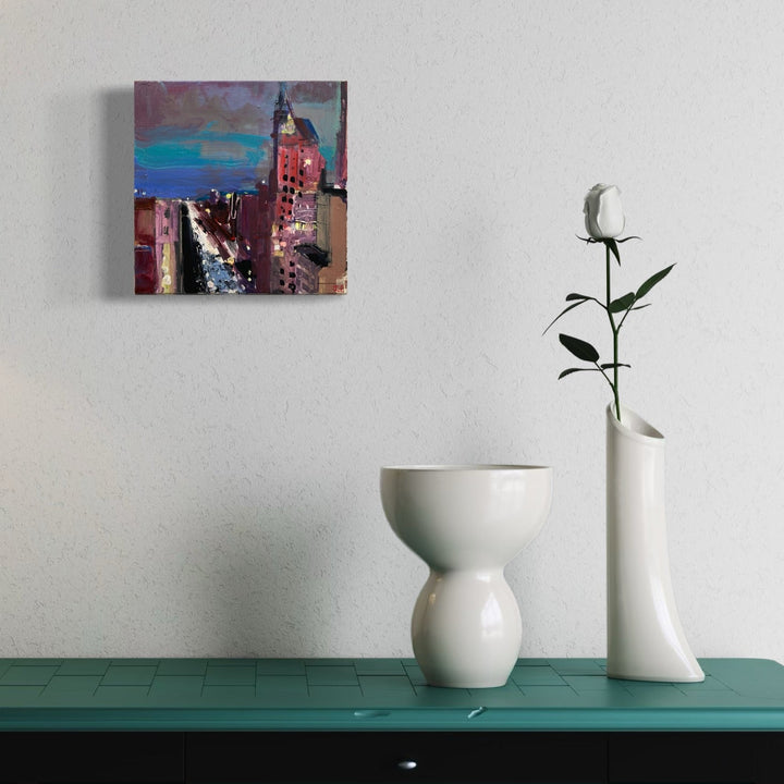 A photo of the artwork Bright Lights, Big City, by Janet L. Pedersen, hanging on a wall.