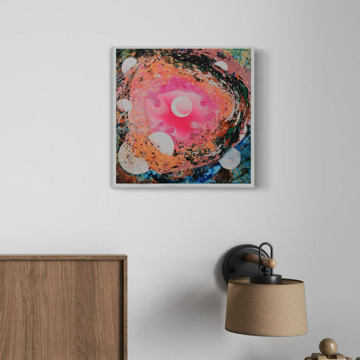 A photo of the artwork Bright Moon Swirl, by Millie Benson, hanging on a wall.