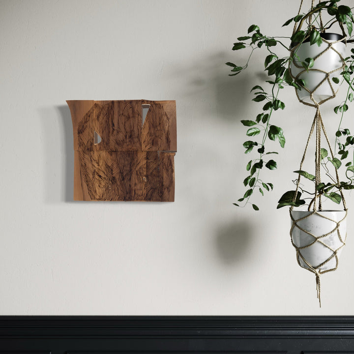 A photo of the artwork Burnt Offering 2, by Zoe Cohen, hanging on a wall.