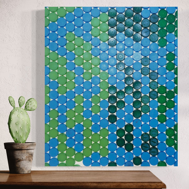 The artwork 'Camouflage' by Dirk Westphal features a mesmerizing grid pattern of circular dots in varying shades of blue and green, creating an abstract mosaic effect. The geometric arrangement of dots forms a subtle camouflage-like pattern, with light and dark elements blending together seamlessly across the 24x20 inch photographic print.