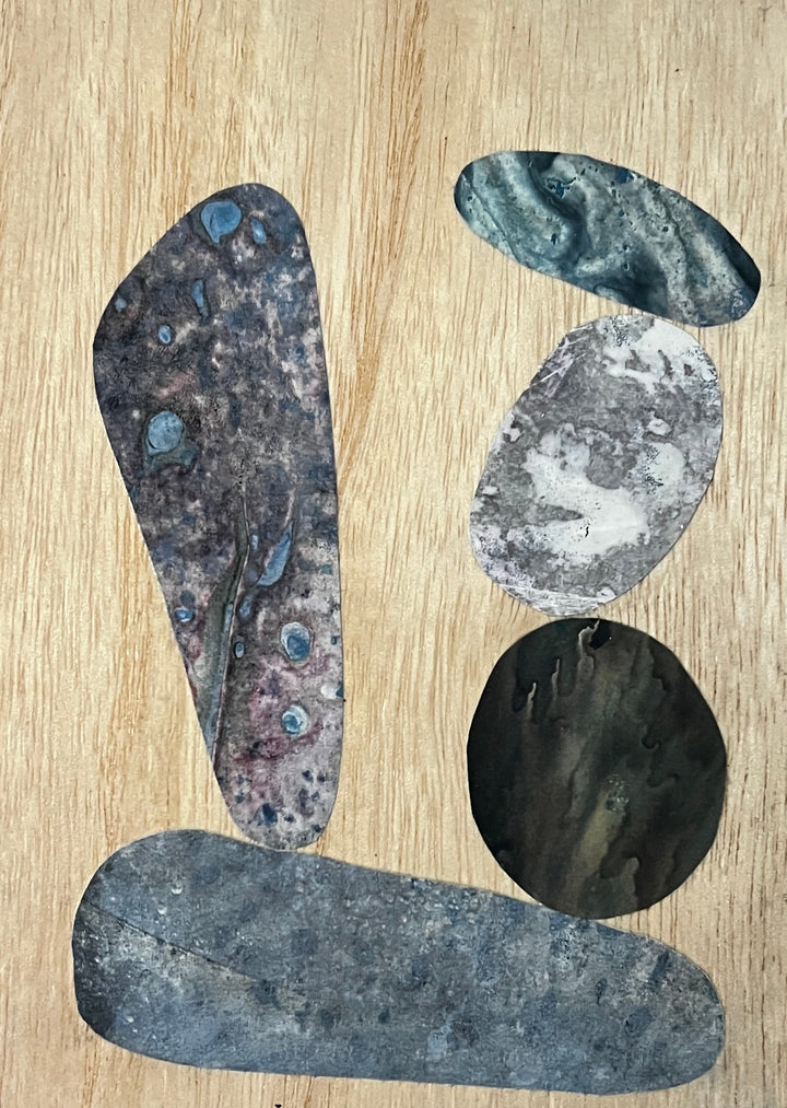 The artwork 'Carled Cairn' features abstract organic shapes arranged on a light wood panel. The composition includes mottled blue-gray forms with textural elements, incorporating alchemic prints and acrylic medium. The shapes suggest stacked stones with varied patterns and marbled effects in cool tones by Sunny Chapman.