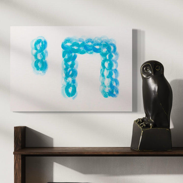 The artwork 'Chai (Alive)' by Ronit Levin Delgado features Hebrew letters formed by vibrant turquoise lipstick kiss marks on white pearl paper. The marks create a dotted, bubble-like pattern forming the word 'Chai', displayed beside a decorative black owl sculpture on a wooden shelf, embodying life and resilience through intimate artistic expression.