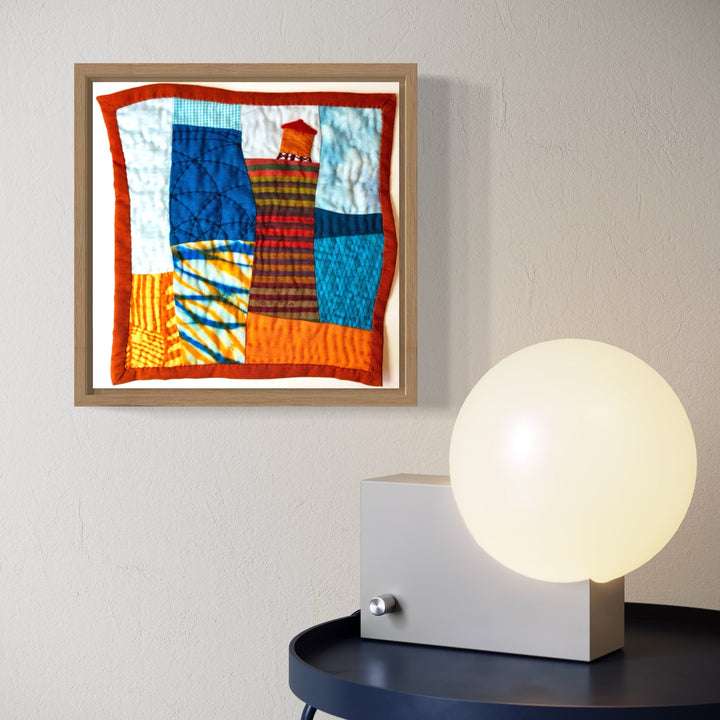 A photo of the artwork Cityscape (Shades of Blue & Orange), by Ann Cofta, hanging on a wall.