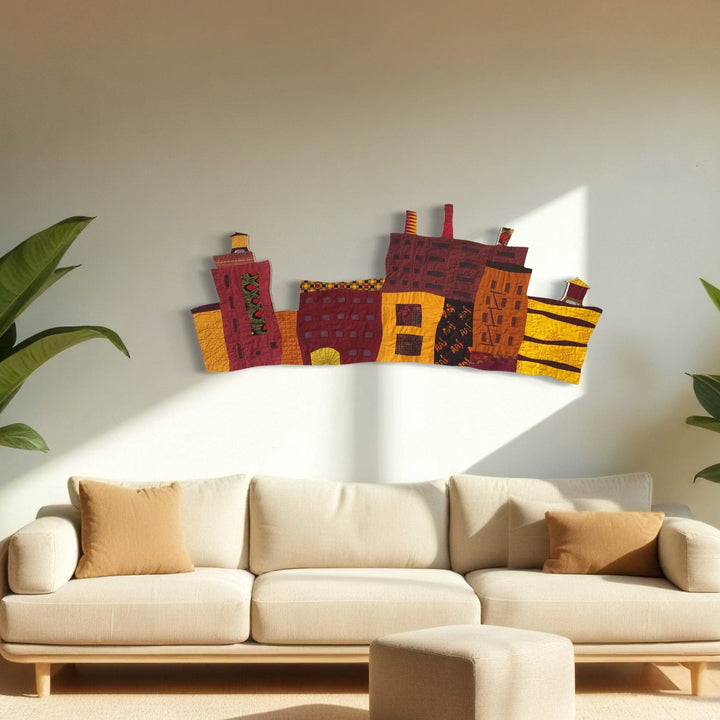 A photo of the artwork Cityscape with Smokestacks and Two Towers, by Ann Cofta, hanging on a wall.