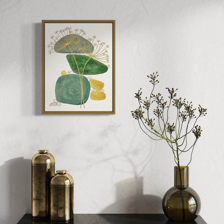 The artwork 'Coming to Fruition' by Jocelyn Benford features organic leaf-like shapes in varying shades of emerald green, accented with delicate golden dandelion-inspired lines radiating outward. The watercolor and mixed media composition shows textured botanical forms arranged in a minimalist, abstract style, framed in gold against white background.