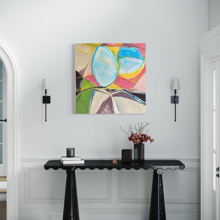 The artwork 'Dueling Skullcaps' by Beth Barry features abstract geometric shapes in vibrant colors, including soft turquoise ovals, bright yellow curves, and pink angular forms. The composition displays bold brushstrokes and dynamic movement across the canvas, with contrasting light and dark elements creating visual depth in acrylic paint.