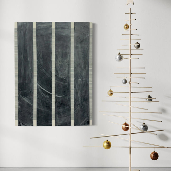 The artwork 'Erasure 46' by Erika Mahr features four vertical panels with deep charcoal and graphite markings creating a moody, abstract composition. Sweeping gestural strokes in dark grey tones create dynamic movement across the segmented surface, while subtle variations in texture and transparency suggest depth and atmosphere. Mixed media on panel, 48x36 inches.