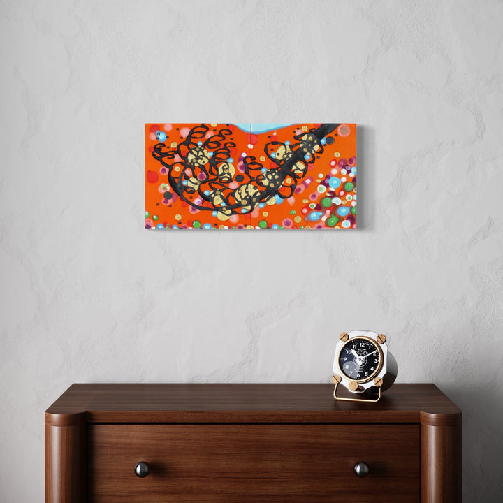 The artwork 'Extend the Epiphanies' by Eric Jiaju Lee features a vibrant diptych with abstract black curvilinear forms floating across an intense orange background. Multicolored circular dots create a playful, constellation-like pattern against the silk canvas, with touches of turquoise blue adding dynamic contrast. Acrylic on silk, 12x24 inches, by Eric Jiaju Lee.