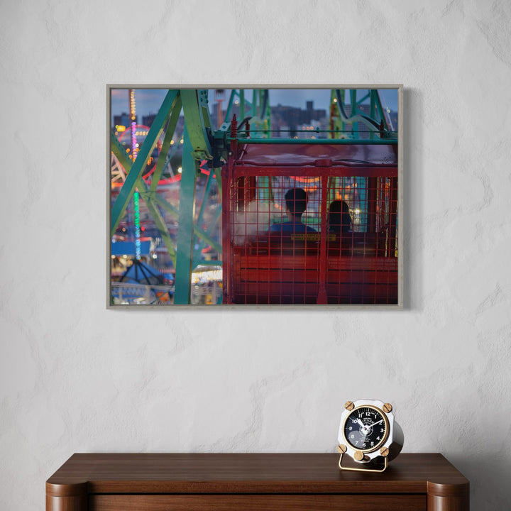 The artwork, Ferris Wheel Ride at Dusk, by Garrett Carroll, displayed in a room.