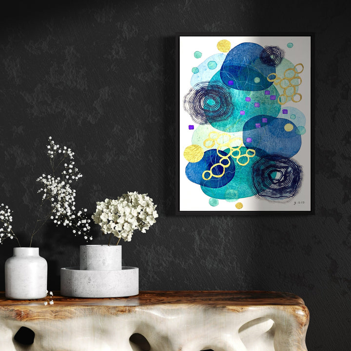 The artwork 'Festive Moments' by Jocelyn Benford features abstract watercolor shapes in deep ocean blues and turquoise, accented with vibrant yellow circular patterns. Spiraling black sketched elements contrast with translucent aqua bubbles, creating a dynamic underwater-like composition. Mixed media techniques blend fluid and geometric forms on white paper, 24x18 inches.