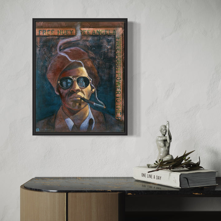 The artwork 'Free Huey' depicts a figure in a brown suit with a rust-colored beret, wearing reflective sunglasses against a deep teal background. The piece features bold brushstrokes in acrylic on canvas, combining urban contemporary style with political art elements. The title appears in orange text across the top. 20x16 inches acrylic painting by JaeMe Bereal