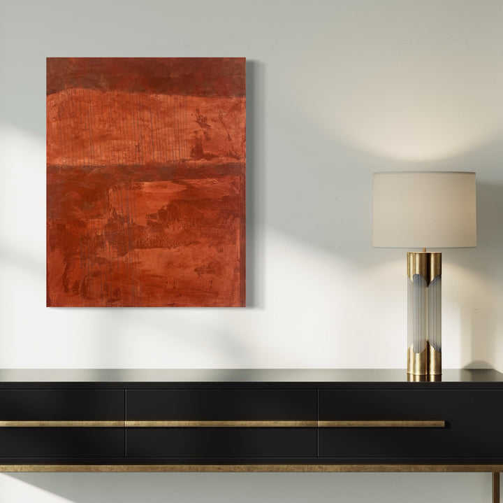 The artwork 'Gray Lines on Rust II' by Diane Englander features a bold abstract composition in rich rust-orange tones with subtle gray linear elements. The mixed media piece combines papers, fabric, and acrylic paint creating textural layers on canvas. The monochromatic rust color field is divided horizontally, suggesting a minimalist landscape aesthetic.