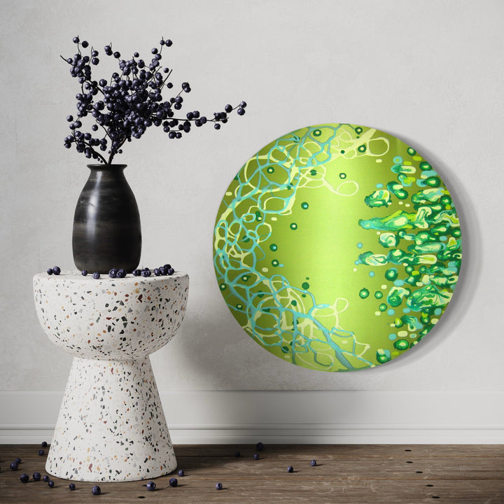 The artwork 'Hailing a Helix' by Eric Jiaju Lee features a vibrant circular composition on silk with swirling patterns in lime green and turquoise. Abstract cellular forms and delicate helix structures float across the luminous surface, creating a dynamic biological aesthetic. The 24-inch round canvas showcases intricate details in acrylic paint, by Eric Jiaju Lee.