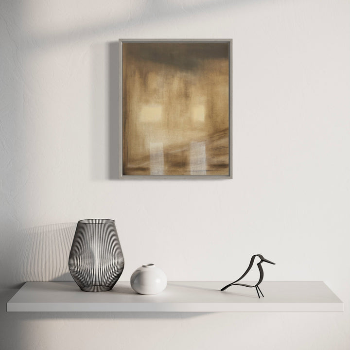 The artwork 'Holding Patterns-2' by Cora Jane Glasser features ethereal golden-brown abstract brushstrokes on stretched linen, displayed in a contemporary silver frame. Below, a minimalist white shelf showcases decorative objects including a ribbed gray vase, white ceramic vessel, and stylized black bird sculpture. Oil on linen, 20x16 inches.