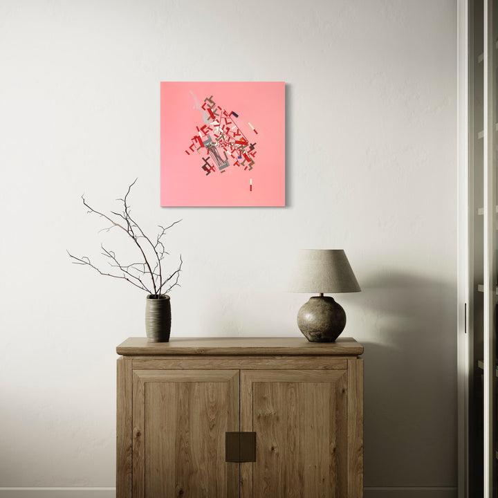 The artwork 'Iiirekiee' by Philippe Halaburda features abstract geometric shapes scattered across a vibrant coral pink background. Angular black and gray forms create a dynamic composition suggesting movement and fragmentation. The mixed media piece, displayed on a 36x36 inch canvas, combines sharp edges and scattered elements in a contemporary minimalist style by Philippe Halaburda.