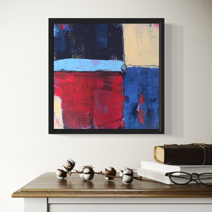 The artwork 'In Between the Giving' by Karen L. Burns features a modern abstract composition with bold geometric blocks of deep navy blue, vibrant red, and cream colors. The acrylic painting showcases textural brushstrokes and layered mixed media elements, creating a dynamic interplay of shapes and tones in a 12x12 inch format.