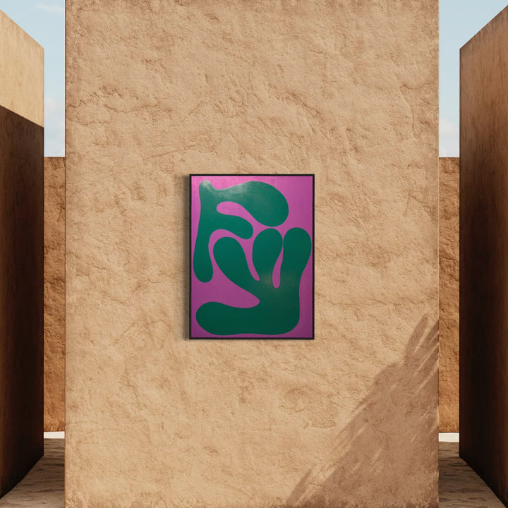 The artwork 'MONSTERA II' by Shadia Sabagh features bold organic shapes in deep forest green against a vibrant magenta background. The abstract composition suggests the distinctive split leaves of a Monstera plant, rendered in a minimalist, modern style. Acrylic on wood, the 36x48 inch piece displays clean lines and strong color contrast.