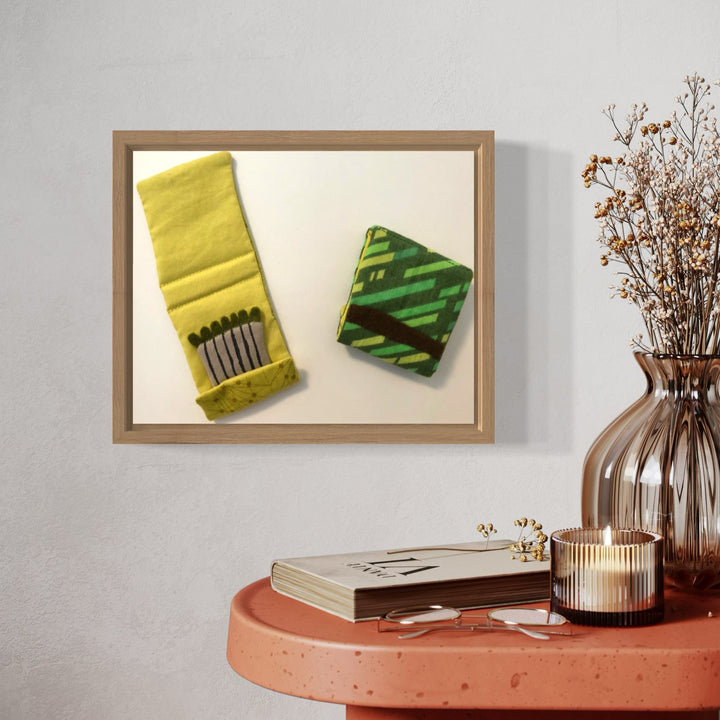 A photo of the artwork Matchbooks (Green), by Ann Cofta, hanging on a wall.