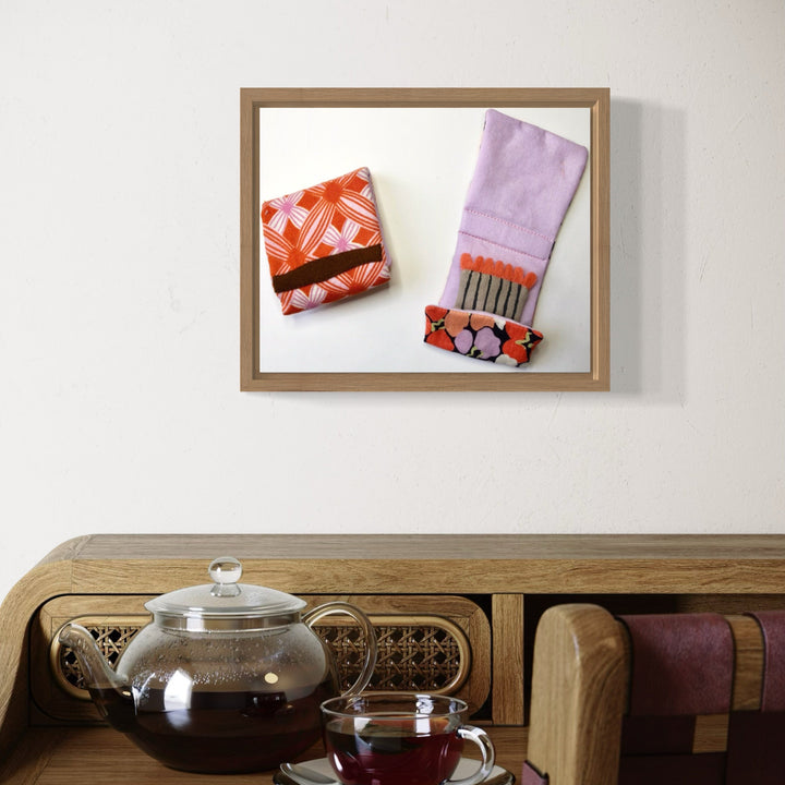 A photo of the artwork Matchbooks (Lilac & Orange), by Ann Cofta, hanging on a wall.