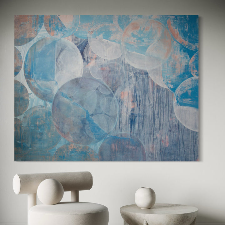 The artwork 'Meditation 23.5' by Carin Kulb Dangot features overlapping translucent circles in varying shades of blue and gray, creating a dreamy, ethereal composition. Subtle coral accents and dripping effects add texture to the 62x78 inch acrylic canvas, evoking a serene, atmospheric quality through layered brushwork and abstracted forms. By Carin Kulb Dangot.