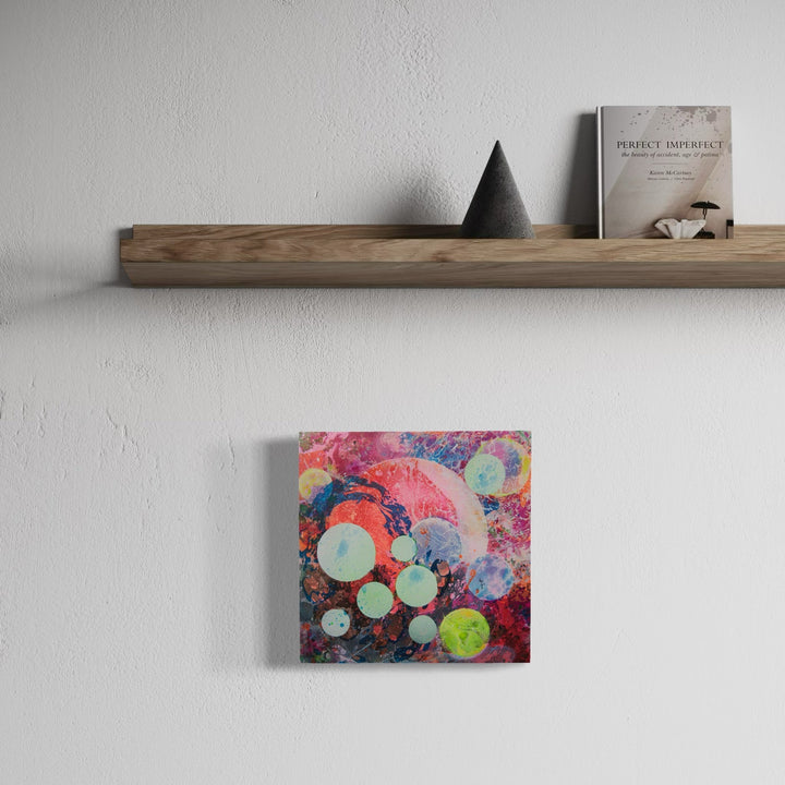 A photo of the artwork My World, by Millie Benson, hanging on a wall.