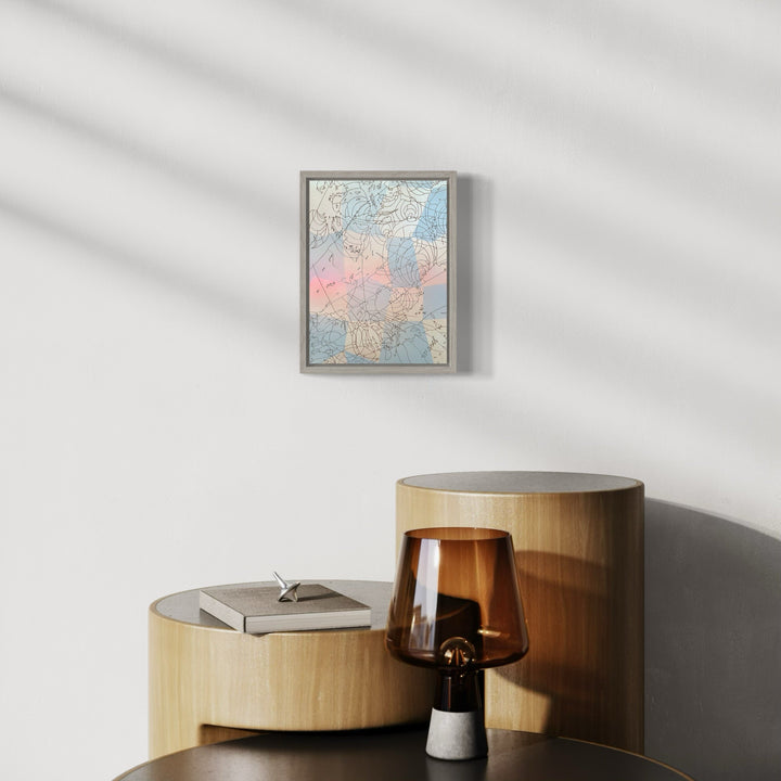 The artwork 'Ocean Hours' by Ann Tarantino features a delicate composition of soft pastel hues, blending pale blues and gentle coral pink in an abstract topographical pattern. Created on a laser-etched panel with acrylic paint, the piece showcases organic flowing lines reminiscent of coastal maps or aerial views, framed in a sleek gray border, measuring 12 by 9 inches.