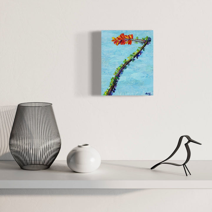 A photo of the artwork Ocotillo Splendor, by Natasha Papousek, hanging on a wall.