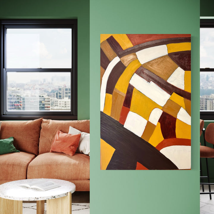 The artwork 'Originality' features abstract geometric shapes in warm earth tones. Bold curves and angular blocks in yellow, brown, cream, and russet create a dynamic composition. The oil painting showcases a modernist style with strong contrasts and flowing lines, creating a rhythmic pattern across the board. By Genevieve Antonello.