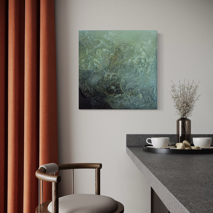 The artwork 'Patient Jeweler' by Abbey Stace features a textural abstract composition in teal and deep emerald tones, created with plaster, acrylic, oil, and sand. The painting showcases a gradient effect from light seafoam green to darker depths, with a rich, organic texture reminiscent of underwater landscapes or mineral formations. 24x24 inch square canvas. By Abbey Stace.