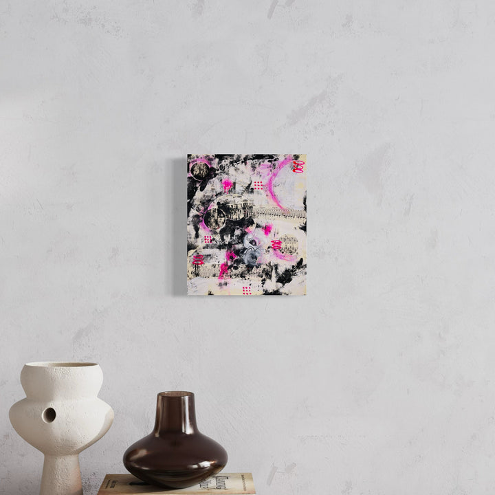 The artwork 'Pink Palimpsest' by Alexandra Jamieson features abstract layered composition with vibrant pink brushstrokes against a black and white textural background. Mixed media collage combines hand-dyed paper elements with acrylic paint and gesso, creating a dynamic interplay of textures and depths. The 13x11 inch piece showcases contemporary abstract expressionist style.