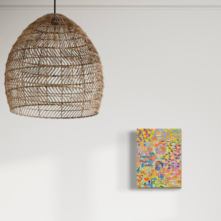 A photo of the artwork Pixel Rainbow 4, by Alexandra Jamieson, hanging on a wall.