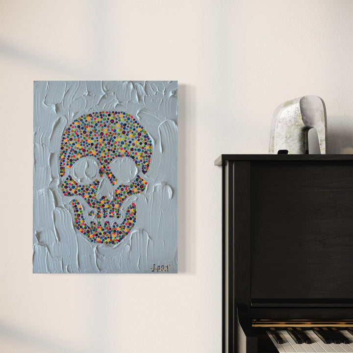 The artwork 'Rainbow' by Jean-Remi Barbier features a vibrant skull composed of multicolored dots against a textured light gray background. The acrylic painting showcases a contemporary pop art style with impasto technique creating dimensional surface effects. The skull design combines playful pointillism with gothic imagery, measuring 24x18 inches.