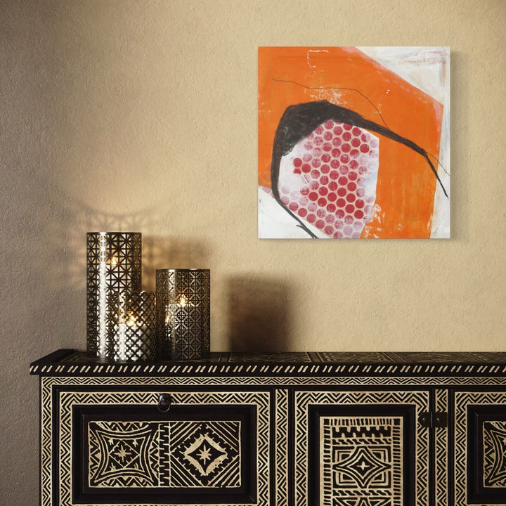 A photo of the artwork Red Dots with Orange and Black, by Diane Englander, hanging on a wall.