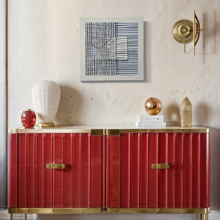 Sentence Structure String 5 by Anne Sherwood Pundyk features abstract black linear patterns on white background, displayed above a modern red and gold credenza. The artwork combines vertical and horizontal lines creating a geometric grid pattern. The archival inkjet print is mounted on wood panel, creating a minimalist monochromatic composition by Anne Sherwood Pundyk.