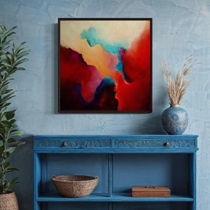 The artwork 'Serene Soul' by Janyce Erlich-Moss features a vibrant abstract composition with dramatic color transitions from deep crimson reds to ethereal turquoise blues, accented by warm peachy tones. The fluid, cloud-like formations create a dynamic interplay of colors, suggesting a meditative atmospheric landscape on acrylic canvas.