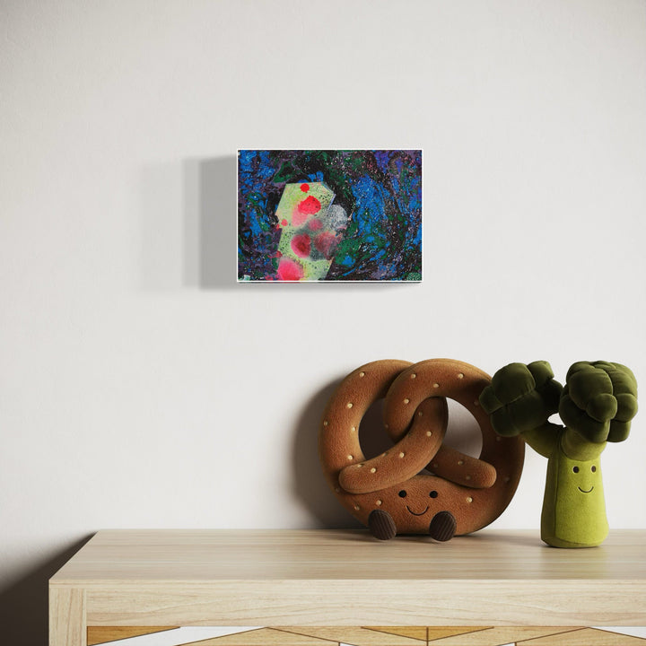 A photo of the artwork Small Moon Decides, by Millie Benson, hanging on a wall.