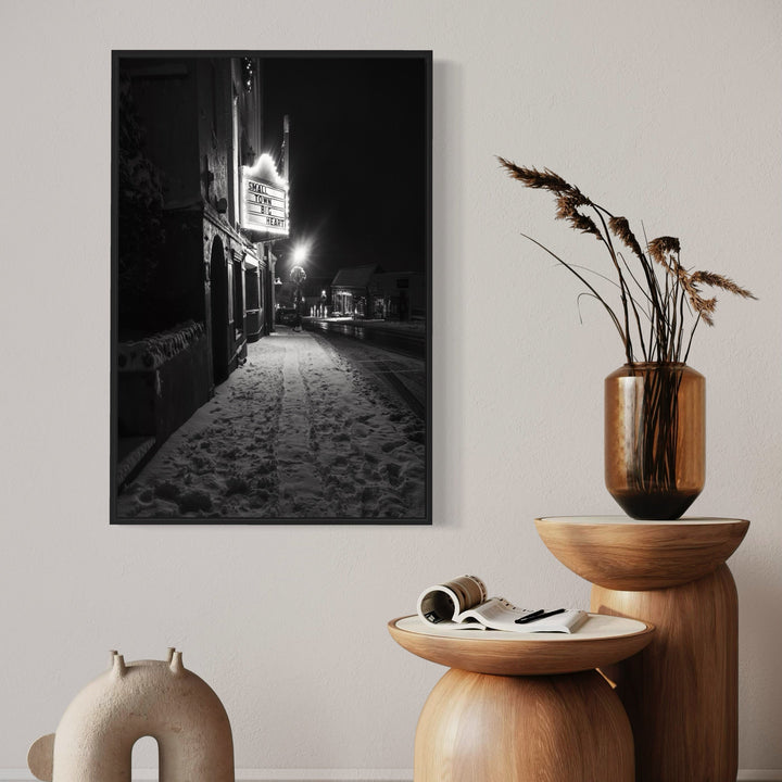 A photo of the artwork Small Town, Big Heart, by Dennis Maida, hanging on a wall.