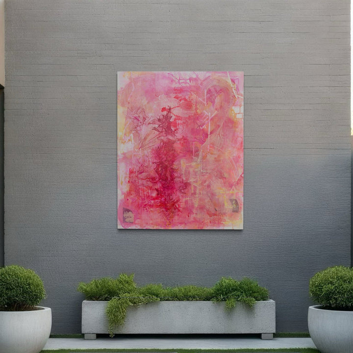 The artwork 'Spring Flowers' by Lisa Petker Mintz features ethereal layers of pink and coral hues blending into soft yellow undertones on canvas. Abstract brushstrokes create a dreamy, watercolor-like effect, suggesting delicate floral forms emerging from a misty background. The 60x48 inch acrylic painting evokes the gentle essence of springtime blooms.