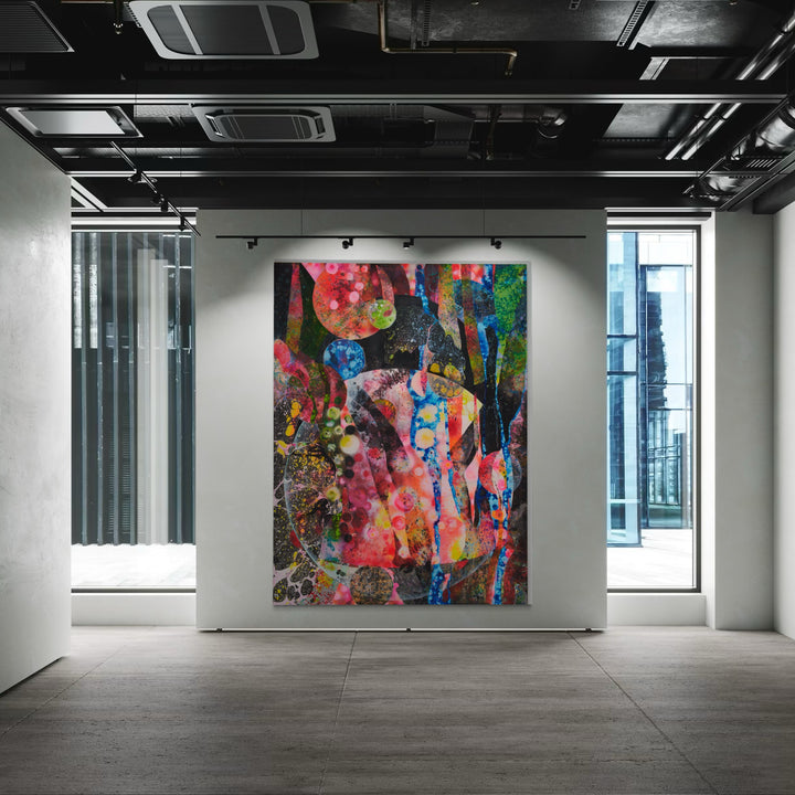 The artwork 'The Mothership' by Millie Benson features a vibrant abstract composition with explosive bursts of pink, blue, and green hues against a dark background. The large-scale mixed media piece showcases dynamic textures created through gouache, spray paint, and crayon techniques, exhibiting fluid forms and geometric patterns that interweave across the canvas.