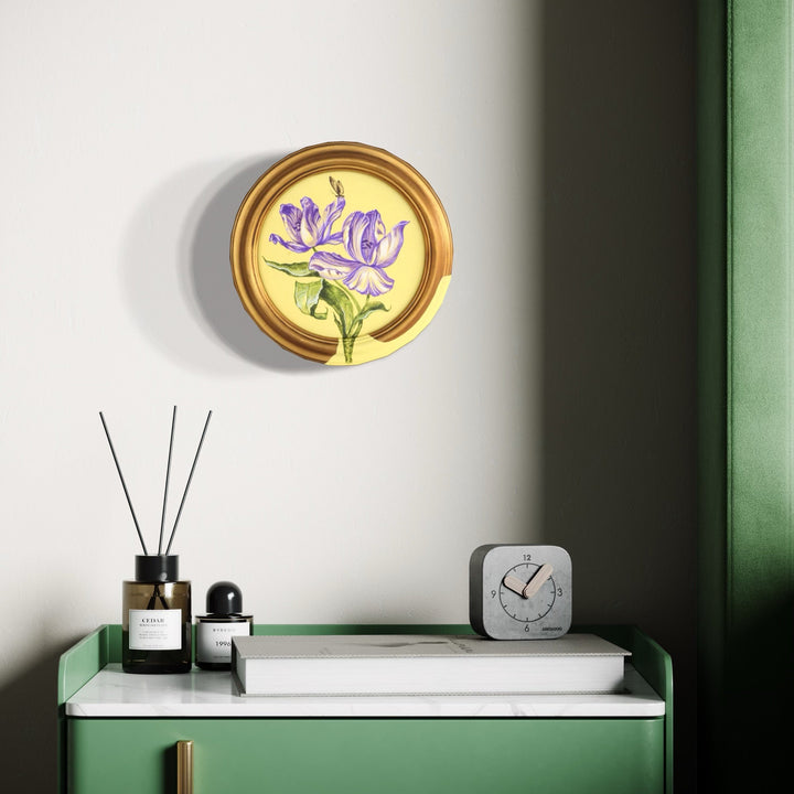 The artwork 'The Walk of the Butterfly' by Carlos Gamez de Francisco features a delicate purple iris flower painted in acrylic on an 8x8 canvas, encased in a circular golden frame. The composition showcases soft lavender petals and green stems against a pale background, creating an elegant botanical study with a contemporary minimalist aesthetic.