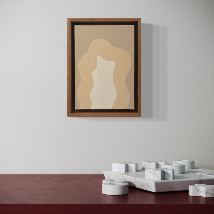 A photo of the artwork White Mini, by Shadia Sabagh, hanging on a wall.