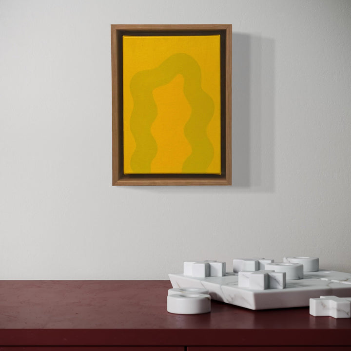 A photo of the artwork Yellow Mini, by Shadia Sabagh, hanging on a wall.