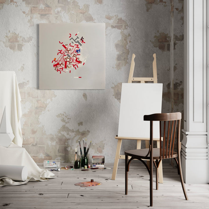 The artwork 'liimisserr' by Philippe Halaburda features an abstract composition with dynamic red shapes scattered across a light beige canvas. The geometric forms appear to burst from the center, creating a sense of movement and energy, complemented by small touches of blue accents. The mixed media piece measures 36x36 inches, displayed in a minimalist art studio setting. By Philippe Halaburda.